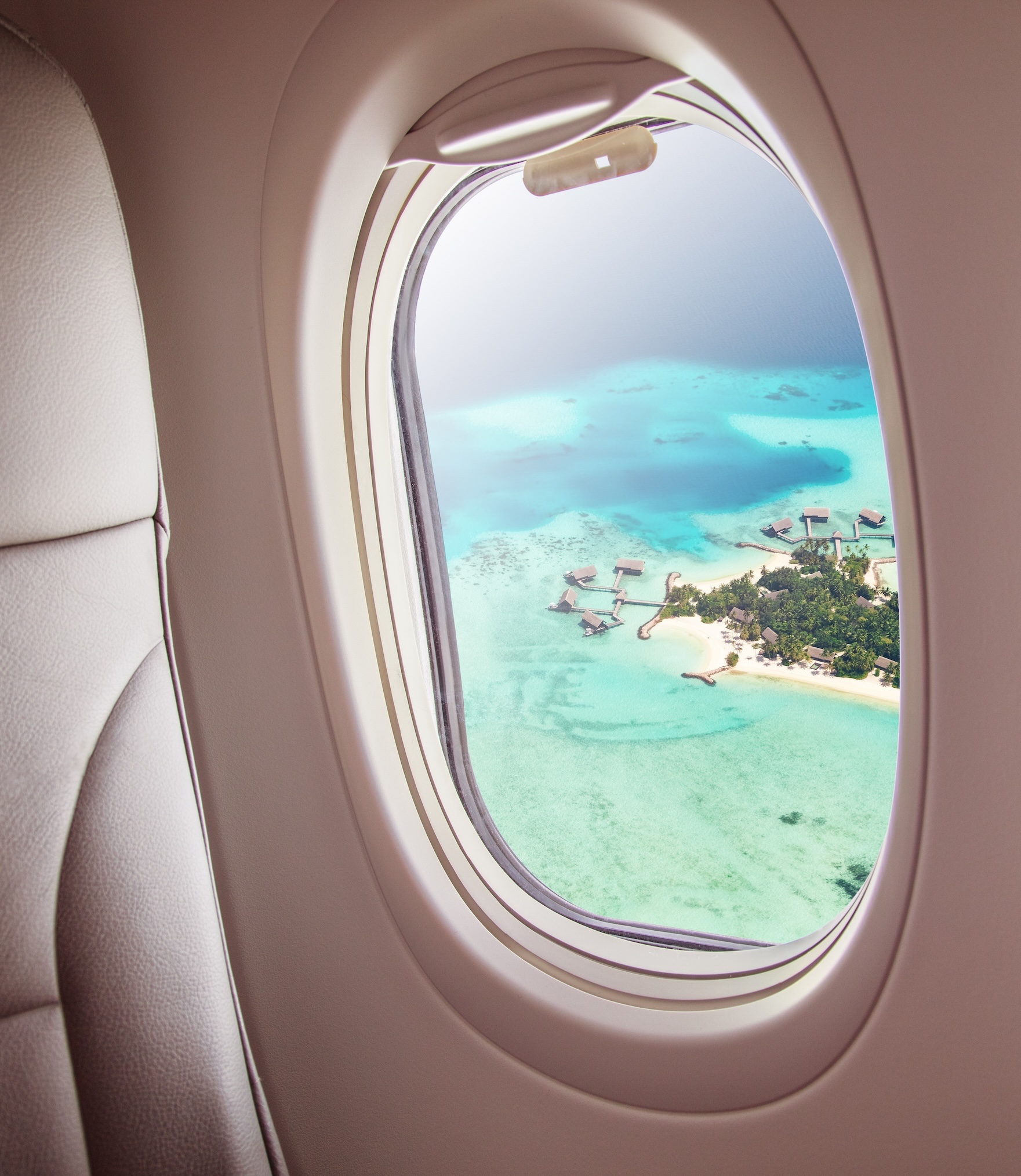 Airplane Window with Maldives Island - NYC Uncovered